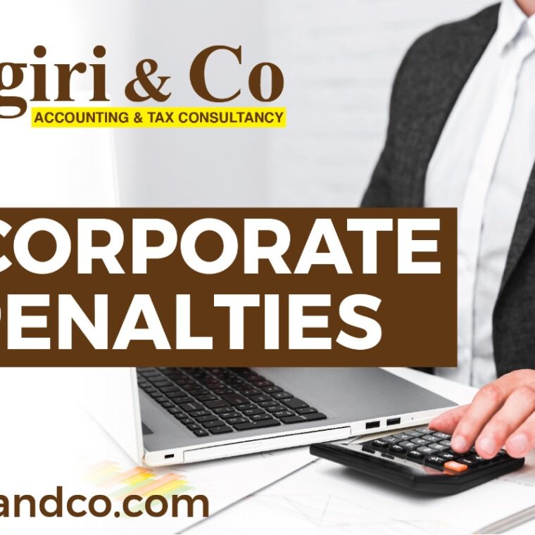 A man using a laptop and calculating the accounts to keep updated about corporate tax penalties.